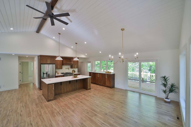 20482 Lord Rd, Center Twp, MN 56465 - kitchen with stainless steel fridge with ice dispenser, light countertops, a large island, beam ceiling, and light wood finished floors