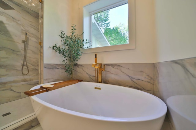 20482 Lord Rd, Center Twp, MN 56465 - bathroom featuring tile walls, a marble finish shower, and a freestanding tub