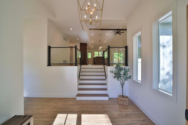 20482 Lord Rd, Center Twp, MN 56465 - staircase featuring plenty of natural light, wood finished floors, a chandelier, and recessed lighting