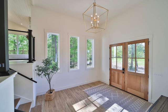 20482 Lord Rd, Center Twp, MN 56465 - foyer entrance with healthy amount of natural light, lofted ceiling, french doors, a chandelier, and wood finished floors
