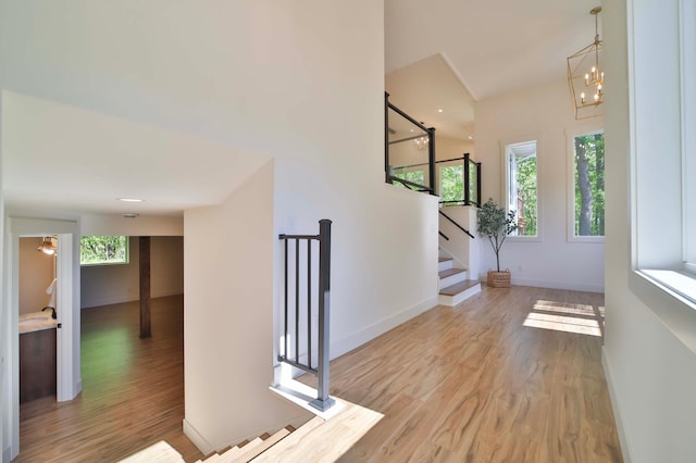20482 Lord Rd, Center Twp, MN 56465 - foyer entrance with healthy amount of natural light, wood finished floors, stairway, and a chandelier