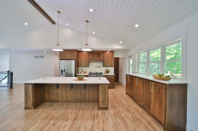 20482 Lord Rd, Center Twp, MN 56465 - kitchen with stainless steel fridge, light wood-style floors, light countertops, a spacious island, and recessed lighting