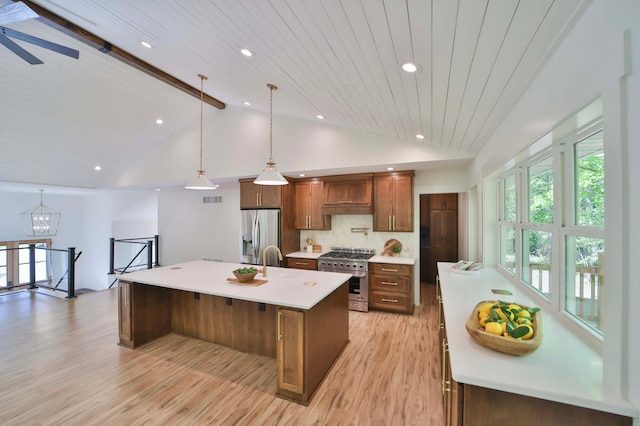 20482 Lord Rd, Center Twp, MN 56465 - kitchen with stainless steel appliances, light countertops, light wood-type flooring, a kitchen island with sink, and hanging light fixtures