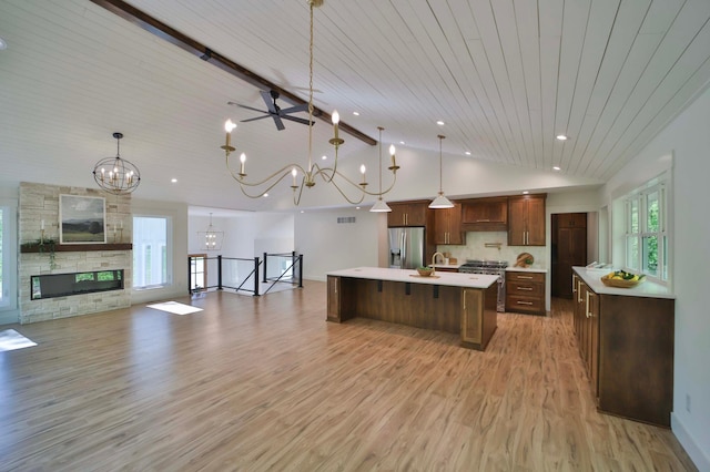 20482 Lord Rd, Center Twp, MN 56465 - kitchen with appliances with stainless steel finishes, light countertops, a chandelier, a center island with sink, and a kitchen bar