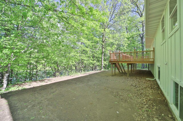 20482 Lord Rd, Center Twp, MN 56465 - view of yard with stairway, a wooden deck, and a forest view