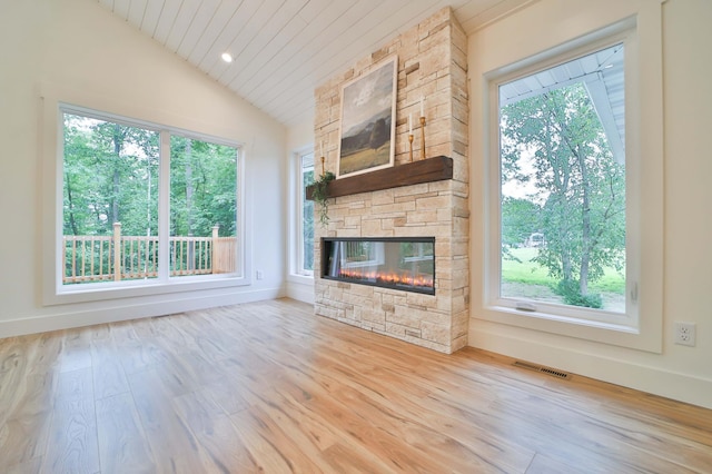 20482 Lord Rd, Center Twp, MN 56465 - unfurnished living room featuring lofted ceiling, plenty of natural light, wood finished floors, a stone fireplace, and wood ceiling