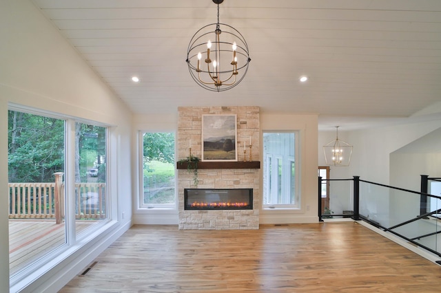 20482 Lord Rd, Center Twp, MN 56465 - unfurnished living room with a chandelier, light wood-style floors, a stone fireplace, vaulted ceiling, and recessed lighting
