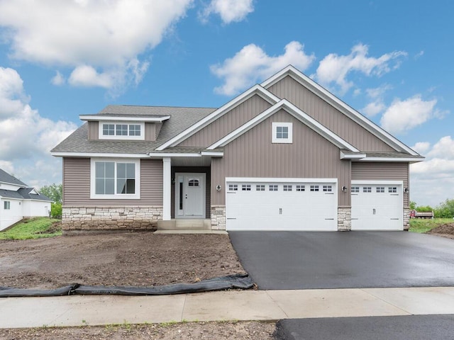 5393 177th St W, Lakeville, MN 55044 - craftsman house featuring driveway, a garage, stone siding, and a shingled roof