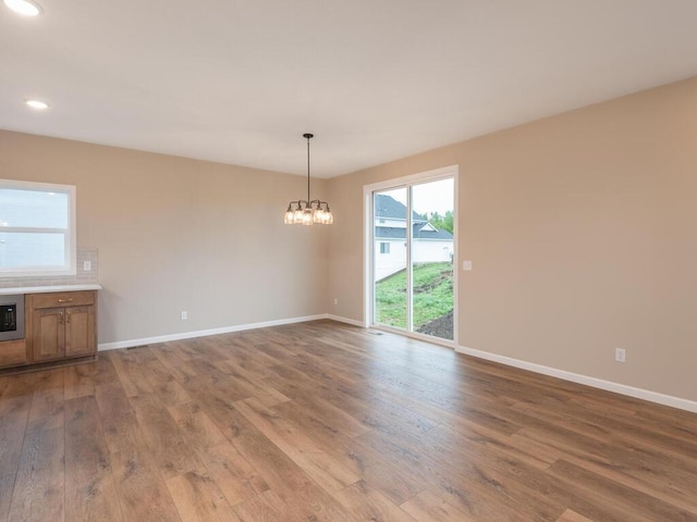 5393 177th St W, Lakeville, MN 55044 - empty room featuring wood finished floors, baseboards, a chandelier, and recessed lighting