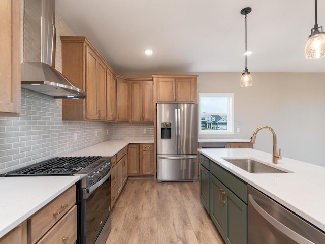 5393 177th St W, Lakeville, MN 55044 - kitchen with stainless steel appliances, wall chimney range hood, a sink, light countertops, and light wood-type flooring