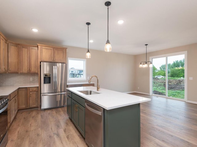 5393 177th St W, Lakeville, MN 55044 - kitchen featuring stainless steel appliances, a sink, light wood-type flooring, light countertops, and tasteful backsplash