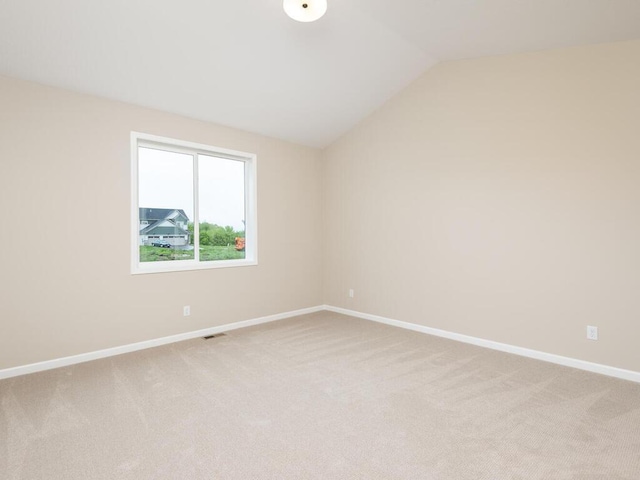5393 177th St W, Lakeville, MN 55044 - spare room featuring vaulted ceiling, light carpet, and baseboards
