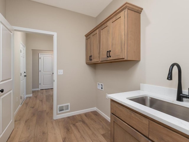 5393 177th St W, Lakeville, MN 55044 - laundry area featuring hookup for a washing machine, cabinet space, light wood-style floors, and baseboards