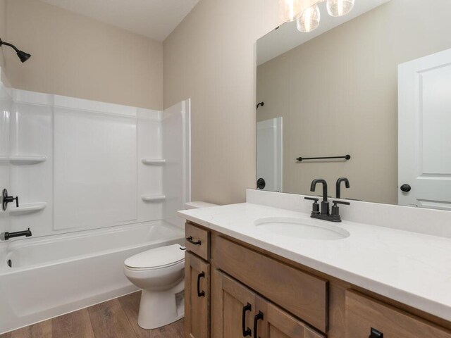5393 177th St W, Lakeville, MN 55044 - bathroom featuring vanity, toilet, bathtub / shower combination, and wood finished floors
