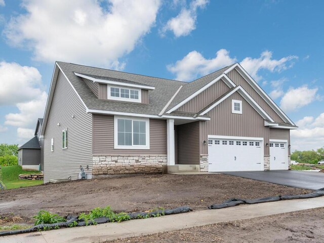 5393 177th St W, Lakeville, MN 55044 - craftsman-style home with stone siding, driveway, an attached garage, and a shingled roof