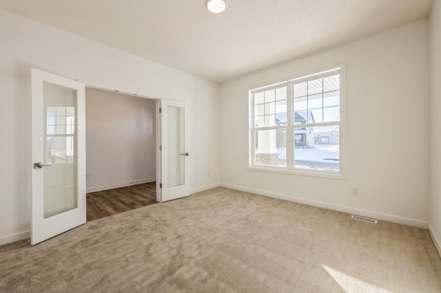 20098 67th Ave, Corcoran, MN 55340 - spare room with french doors, carpet floors, and baseboards