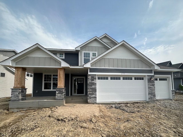 6730 Tamarack Ln, Corcoran, MN 55340 - craftsman-style house with board and batten siding, a garage, stone siding, and a porch