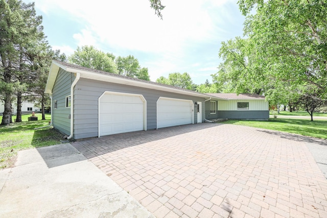 1202 Ridgeview Ter NE, Alexandria, MN 56308 - view of front of home featuring decorative driveway, a front lawn, and an attached garage