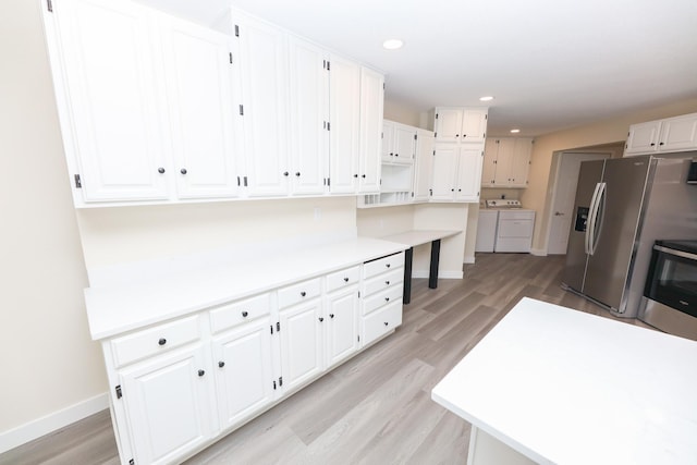 1202 Ridgeview Ter NE, Alexandria, MN 56308 - kitchen featuring washer and clothes dryer, electric range, light wood-style floors, baseboards, and recessed lighting