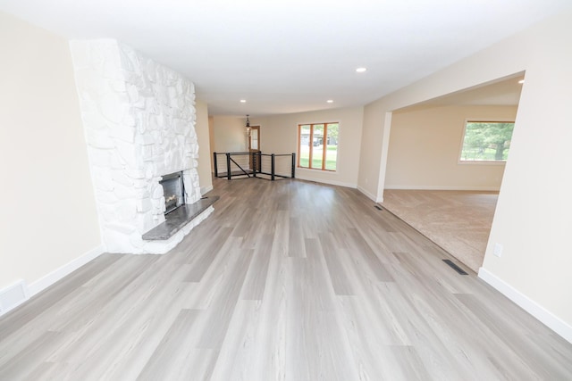 1202 Ridgeview Ter NE, Alexandria, MN 56308 - unfurnished living room featuring plenty of natural light, light wood finished floors, baseboards, and recessed lighting