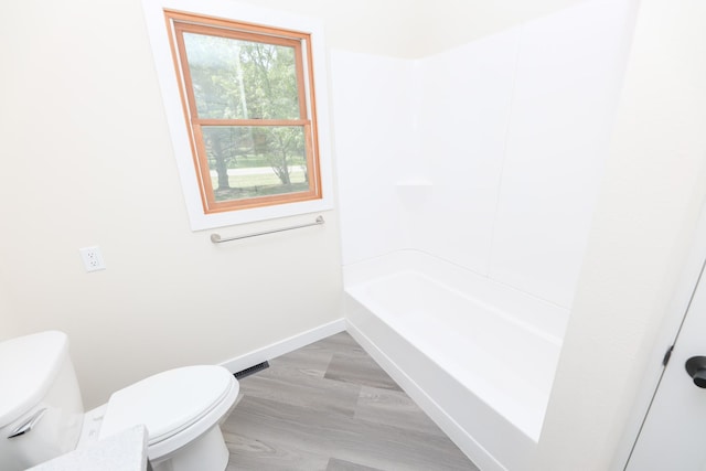 1202 Ridgeview Ter NE, Alexandria, MN 56308 - full bath with toilet, baseboards, wood finished floors, and shower / bathtub combination
