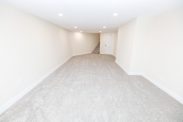 1202 Ridgeview Ter NE, Alexandria, MN 56308 - finished below grade area with light carpet, stairway, recessed lighting, and baseboards