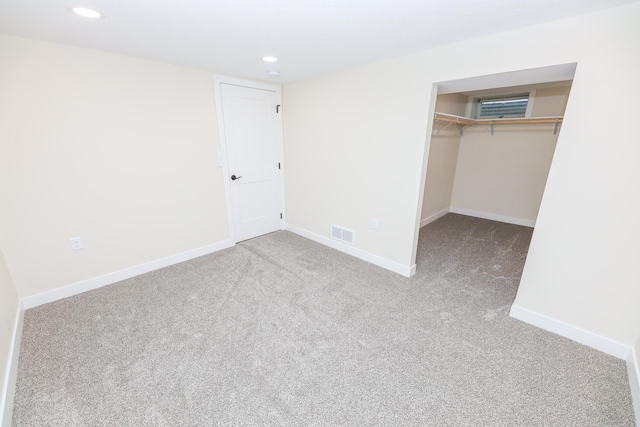 1202 Ridgeview Ter NE, Alexandria, MN 56308 - unfurnished bedroom featuring carpet floors, recessed lighting, a closet, baseboards, and a walk in closet