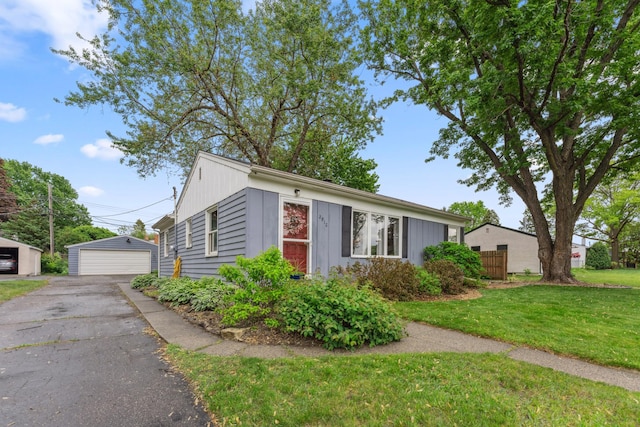2918 Asbury St, Roseville, MN 55113 - view of front facade with a detached garage, a front lawn, and an outbuilding
