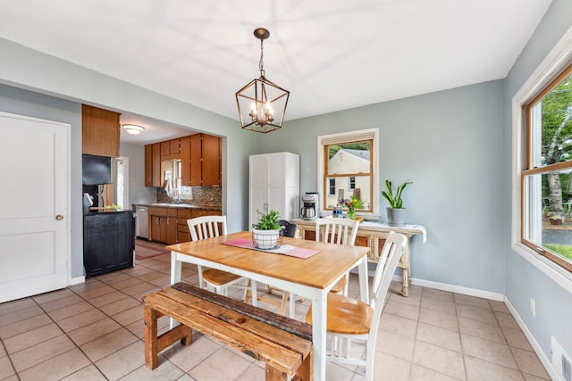 2918 Asbury St, Roseville, MN 55113 - dining area with light tile patterned flooring, baseboards, and a chandelier