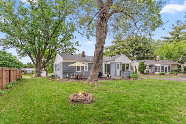 2918 Asbury St, Roseville, MN 55113 - rear view of house with a fire pit, a patio, and a chimney