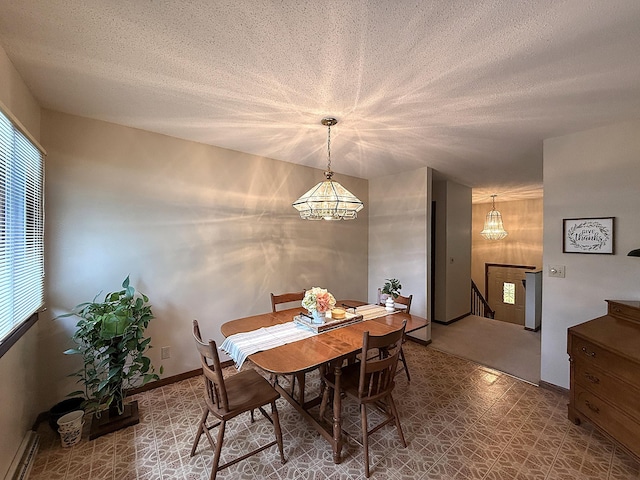 1646 5th St, Montevideo, MN 56265 - dining space with plenty of natural light, a chandelier, a textured ceiling, and tile patterned floors