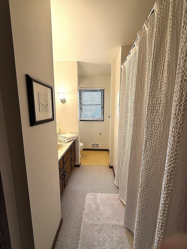 1646 5th St, Montevideo, MN 56265 - full bathroom featuring toilet, double vanity, and baseboards