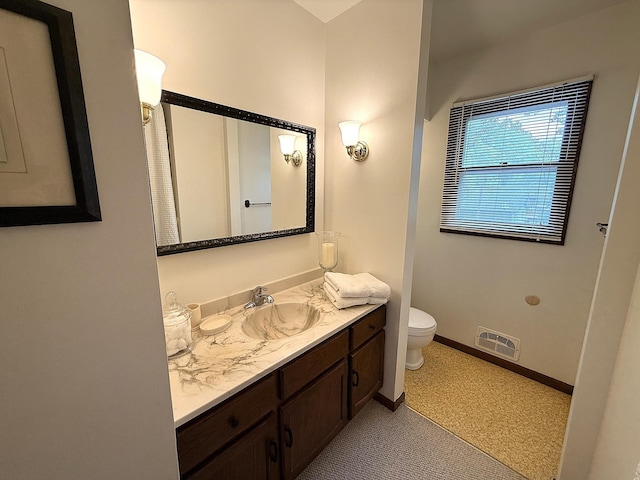 1646 5th St, Montevideo, MN 56265 - bathroom with vanity, toilet, and baseboards