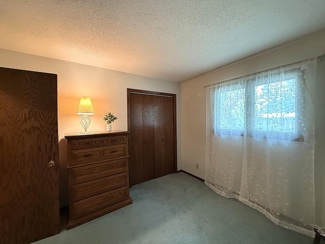 1646 5th St, Montevideo, MN 56265 - unfurnished bedroom with carpet flooring, a textured ceiling, a closet, and baseboards