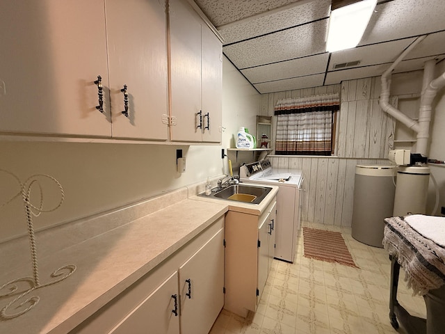 1646 5th St, Montevideo, MN 56265 - laundry room with washing machine and clothes dryer, cabinet space, light flooring, and wooden walls