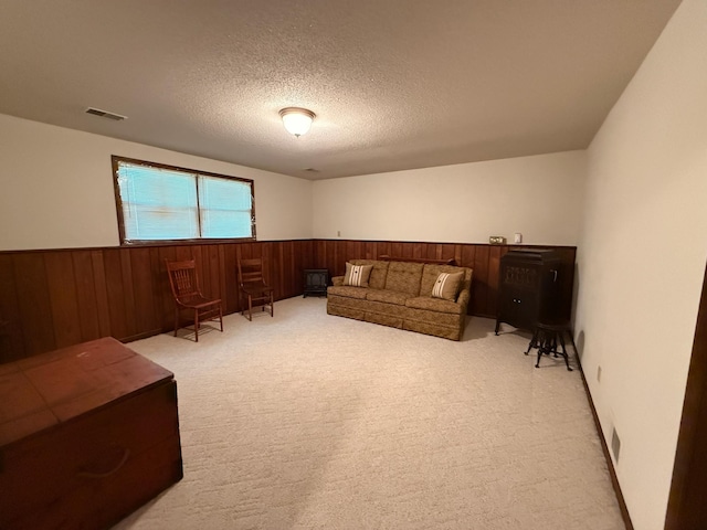 1646 5th St, Montevideo, MN 56265 - living area with a wainscoted wall, wooden walls, light carpet, and a textured ceiling