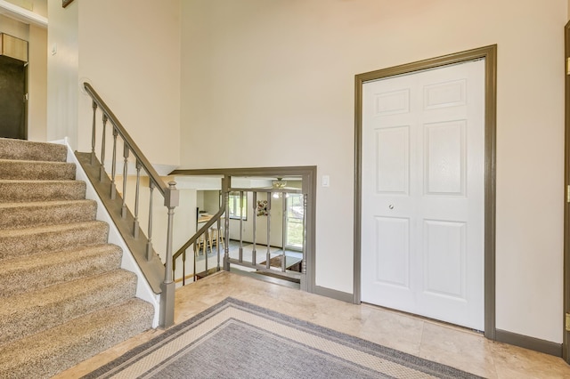 4230 Odegard Ave N, Baytown Twp, MN 55082 - tiled foyer entrance featuring baseboards, stairway, and a towering ceiling