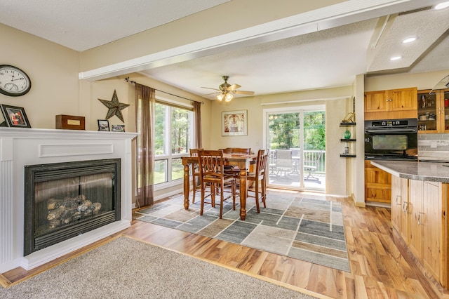 4230 Odegard Ave N, Baytown Twp, MN 55082 - dining area featuring light wood-type flooring, a textured ceiling, a fireplace, a ceiling fan, and recessed lighting
