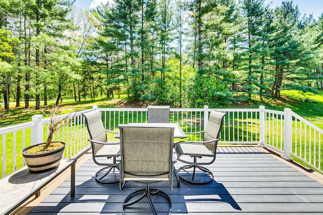 4230 Odegard Ave N, Baytown Twp, MN 55082 - wooden terrace featuring outdoor dining space, a lawn, and view of scattered trees