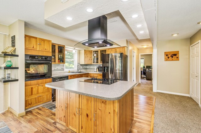 4230 Odegard Ave N, Baytown Twp, MN 55082 - kitchen featuring black appliances, a sink, island range hood, a kitchen island, and glass insert cabinets