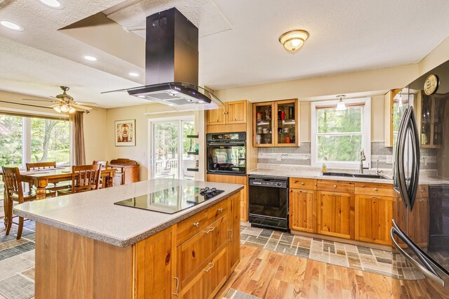 4230 Odegard Ave N, Baytown Twp, MN 55082 - kitchen featuring black appliances, island exhaust hood, a sink, plenty of natural light, and recessed lighting