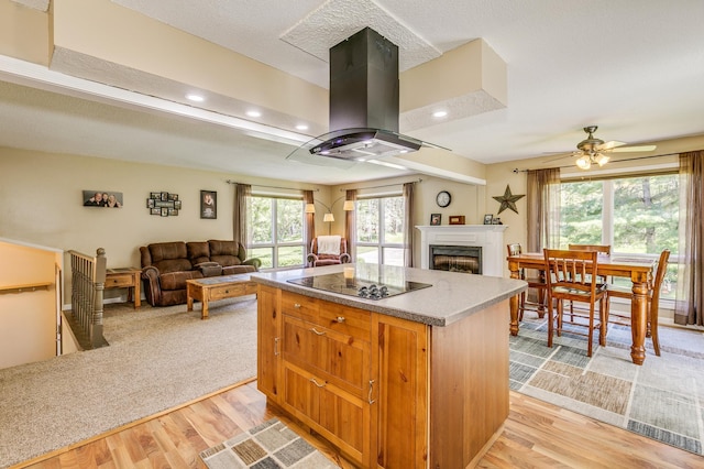 4230 Odegard Ave N, Baytown Twp, MN 55082 - kitchen featuring black electric cooktop, a center island, light wood-style flooring, open floor plan, and recessed lighting