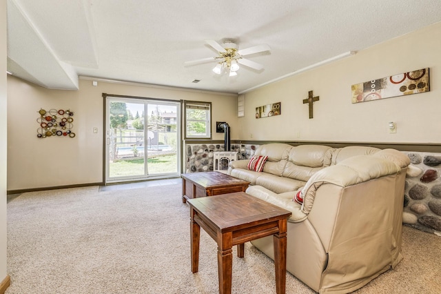 4230 Odegard Ave N, Baytown Twp, MN 55082 - living room featuring a wood stove, light carpet, ceiling fan, baseboards, and ornamental molding
