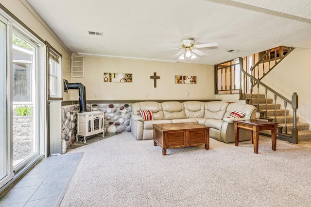 4230 Odegard Ave N, Baytown Twp, MN 55082 - carpeted living area with a wood stove, a ceiling fan, stairway, and a textured ceiling