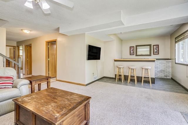 4230 Odegard Ave N, Baytown Twp, MN 55082 - carpeted living room with baseboards, a ceiling fan, and a textured ceiling