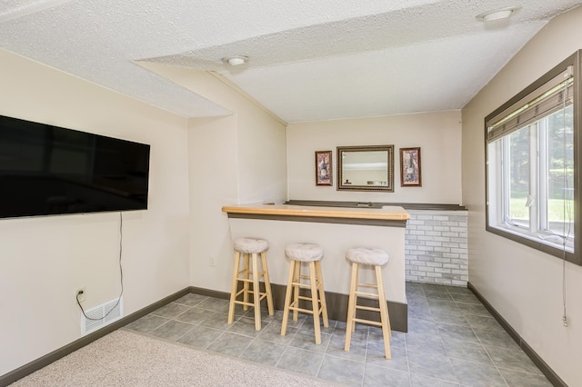 4230 Odegard Ave N, Baytown Twp, MN 55082 - indoor bar featuring baseboards, a textured ceiling, and tile patterned floors