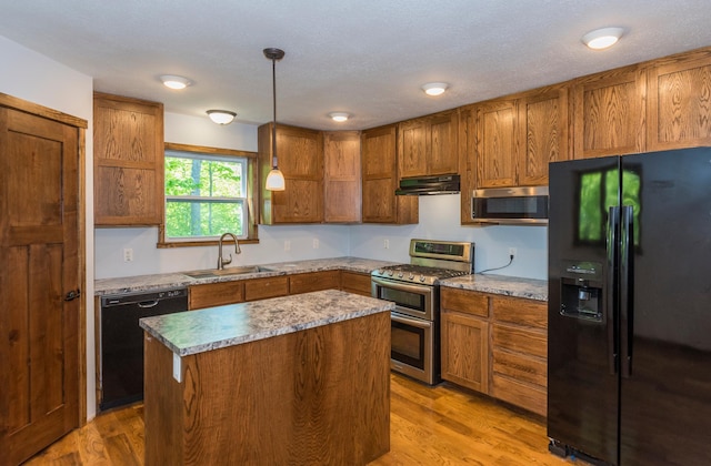 8296 Gladstone Lake Rd, Lake Edward Twp, MN 56401 - kitchen with black appliances, a sink, under cabinet range hood, brown cabinetry, and light wood-style floors