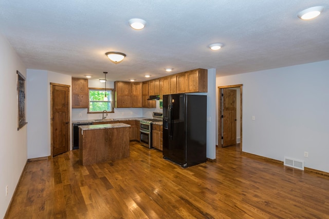 8296 Gladstone Lake Rd, Lake Edward Twp, MN 56401 - kitchen featuring black appliances, brown cabinetry, dark wood-style flooring, a center island, and under cabinet range hood