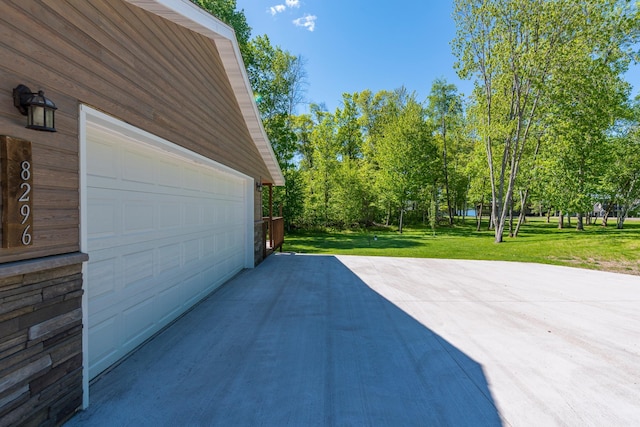 8296 Gladstone Lake Rd, Lake Edward Twp, MN 56401 - view of patio featuring a garage and concrete driveway