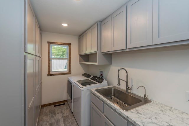 8296 Gladstone Lake Rd, Lake Edward Twp, MN 56401 - washroom featuring separate washer and dryer, cabinet space, dark wood-type flooring, baseboards, and recessed lighting